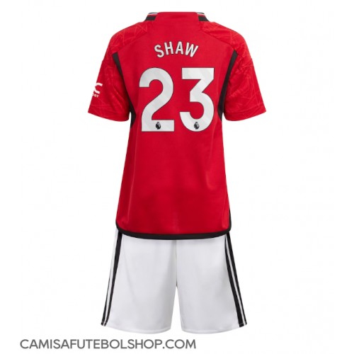 Camisa de time de futebol Manchester United Luke Shaw #23 Replicas 1º Equipamento Infantil 2023-24 Manga Curta (+ Calças curtas)